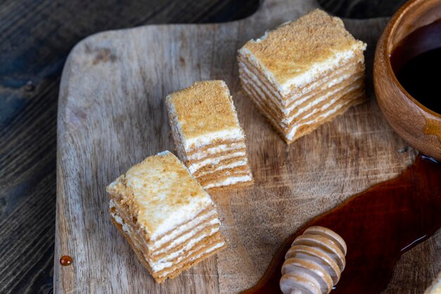 Cake made of thin honey cakes and a thin creamy layer with vanilla flavor cake using flour honey dairy products