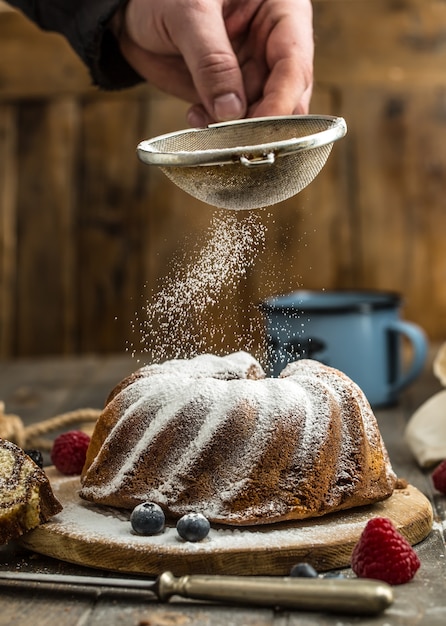 Cake. Marble cake cup of coffee powder sugar kitchen vintage utensil and fresh fruit berries.