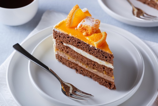 Cake orange and coffee on a light wooden table