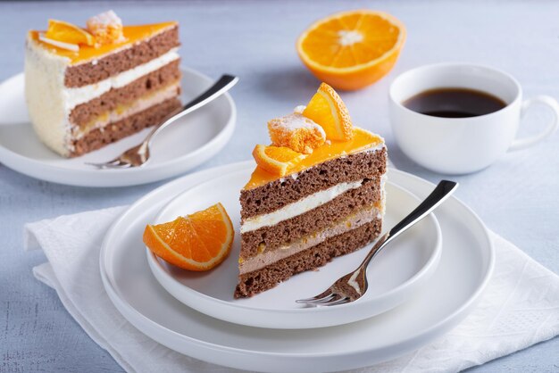 Cake orange and coffee on a light wooden table