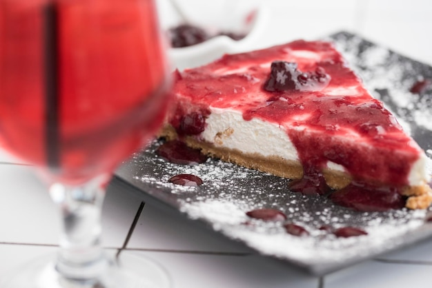 Cake in plate by drink on floor