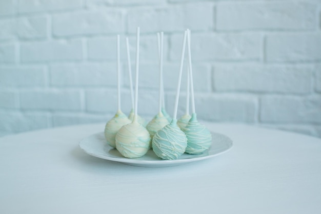 Cake pops on a stick on a plate