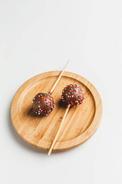 Cake pops on wooden stand 