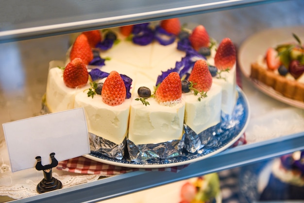 Cake on shelf with cake strawberry and blueberry