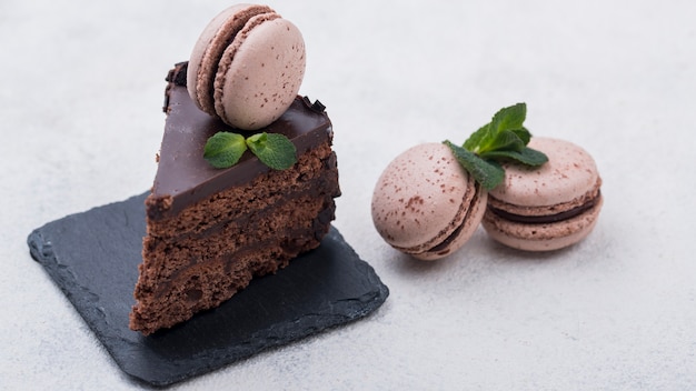 Cake on slate with macarons and mint