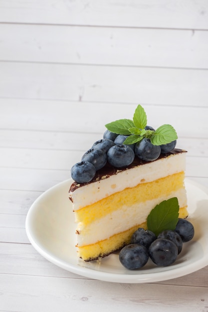 Cake of a souffle with glaze and fresh blueberries. copy space