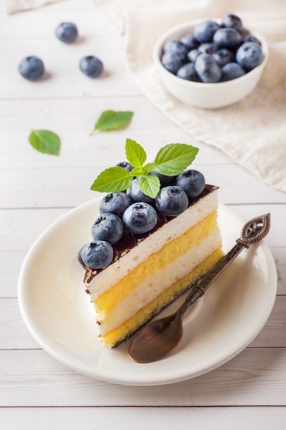 Cake of a souffle with glaze and fresh blueberries.