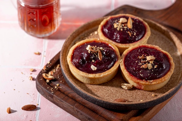 Cake tart with berry filling and nuts close up