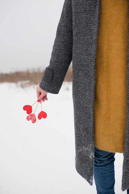 Cake toppers in the hands of a girl in winter