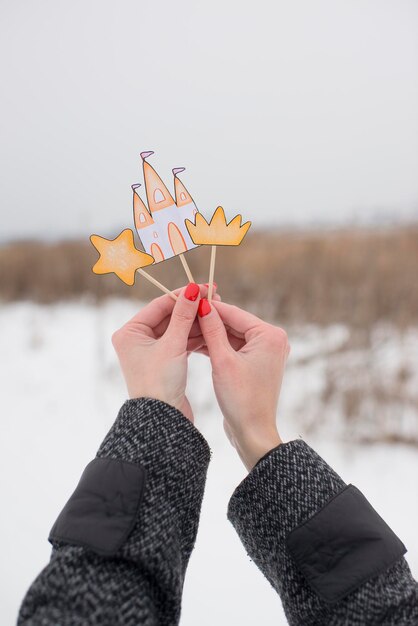 Cake toppers in the hands of a girl in winter