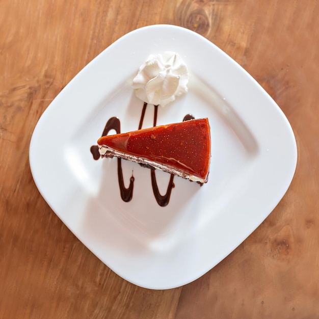 Cake on white plate on the wooden table