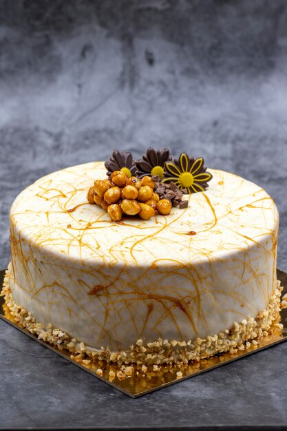 Cake with banana and croquant on a dark background