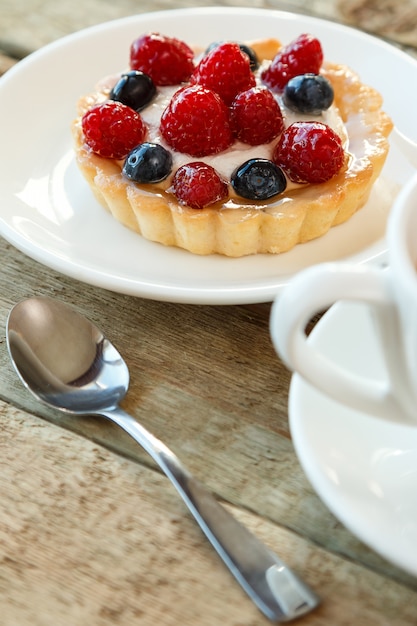 Cake with berries and cup of coffee