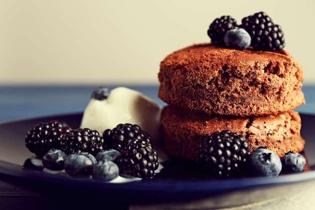 Cake with berries on wooden table