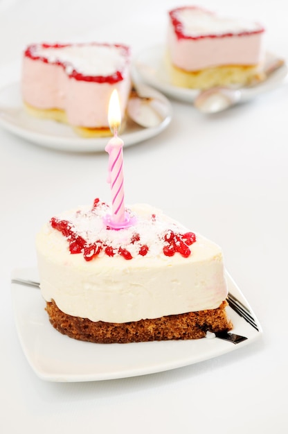 Cake with a candle on white table