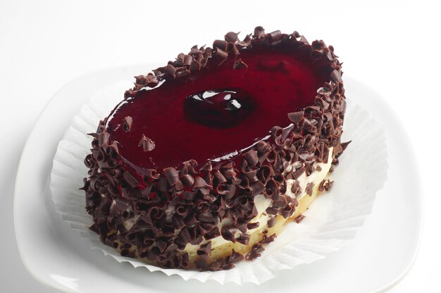 Cake with chocolate and cherry jelly on white background closeup