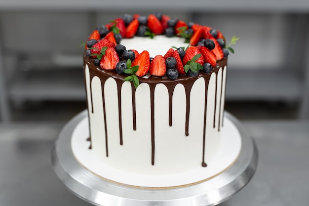 Cake with chocolate streaks and berries.