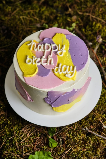 Cake with chocolate on a wooden table. Cake decorated with fresh berries and raspberry leaves. Dessert for wedding and birthday. Delicious and beautiful dessert.