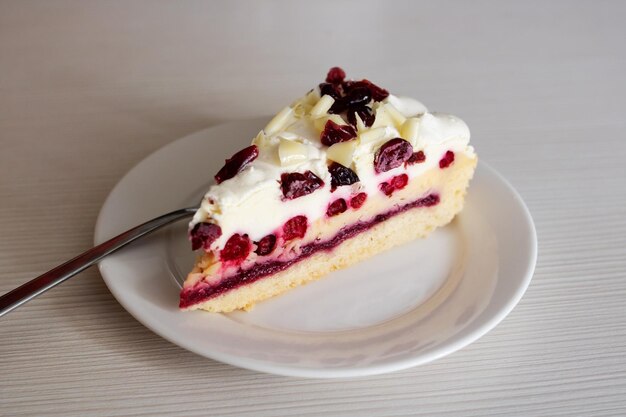 Cake with cranberries on a white plate