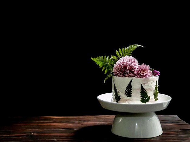 A cake with a fern leaf on top