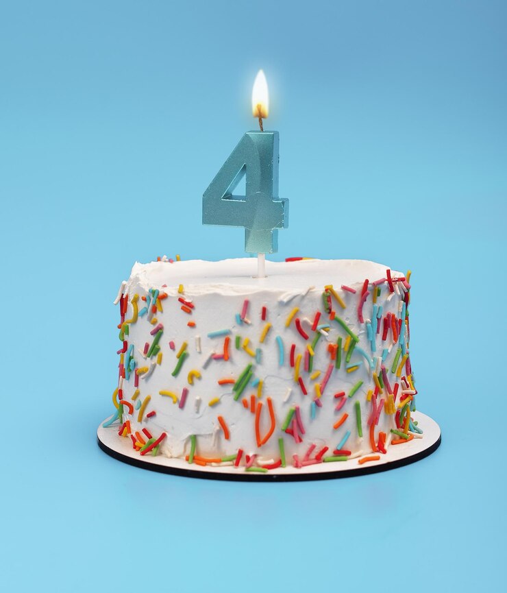 Cake with four candles for 4th birthday party Happy celebration with blue white background