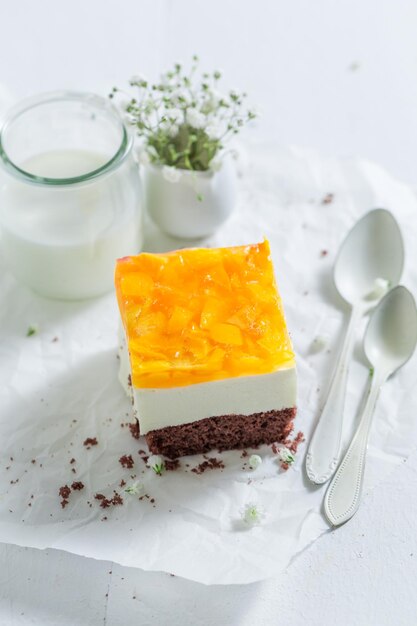 Cake with peaches and jelly served with coffee