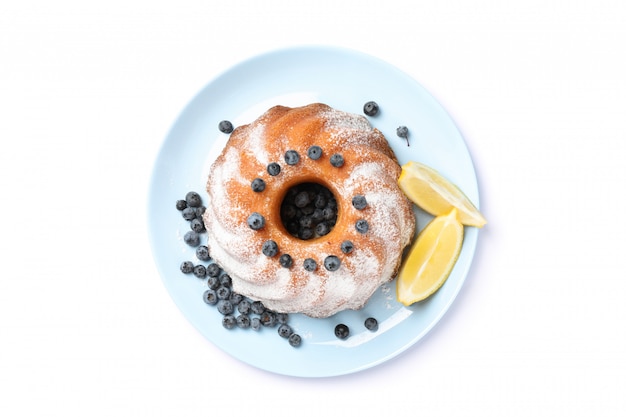 Cake with powdered sugar, blueberry and lemon isolated on white background