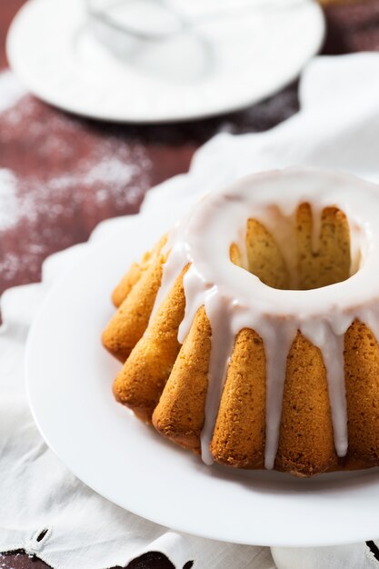 Cake with sugar glaze on white plate