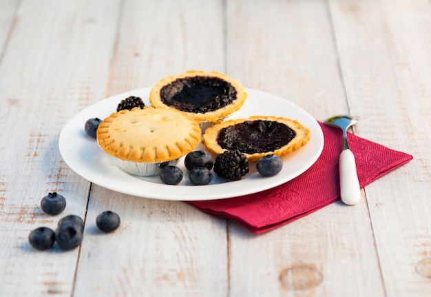 Cakes with blueberries on wooden boards