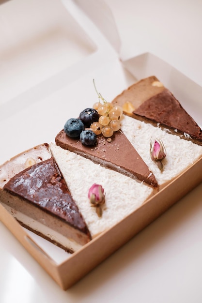 Cakes with nuts chocolate and berries in box