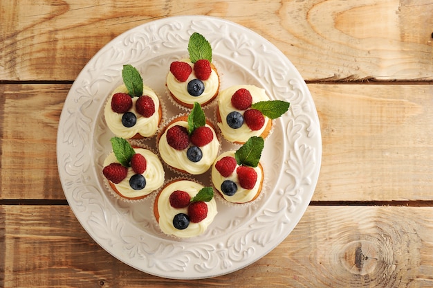 Cakes with raspberries and blueberries on a plate