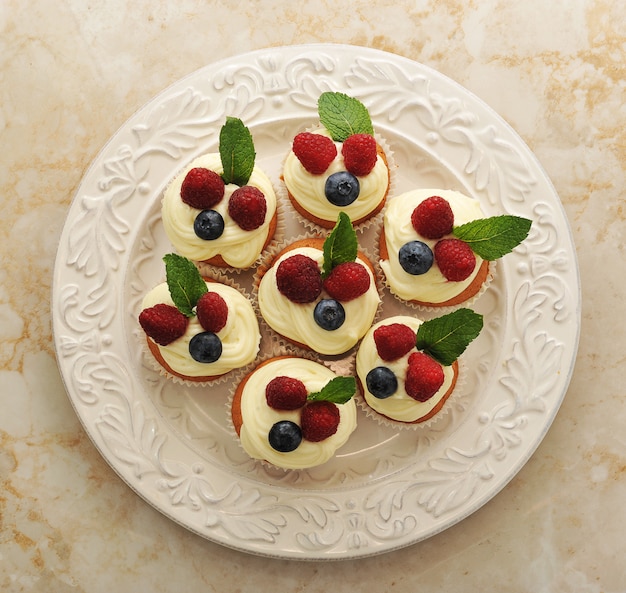 Cakes with raspberries and blueberries on a plate 