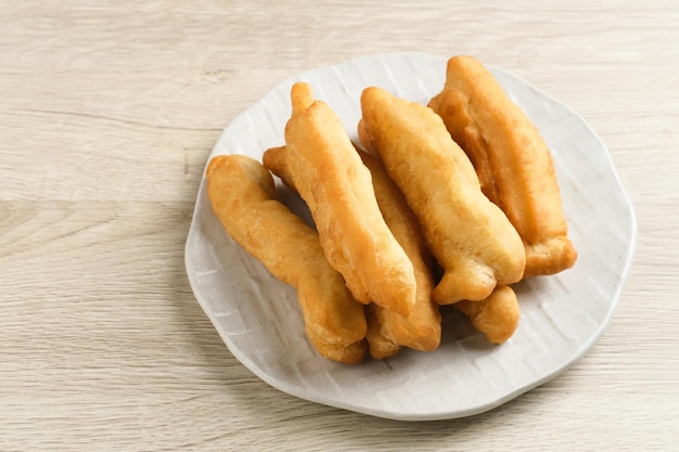 Cakwe or Cakue or Youtiao is traditional Chinese snack long goldenbrown deepfried strip of dough