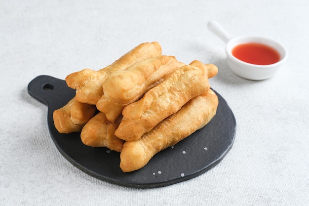 Cakwe or Cakue or Youtiao is traditional Chinese snack long goldenbrown deepfried strip of dough