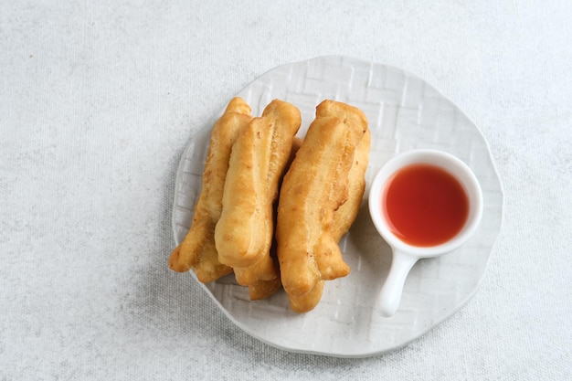 Cakwe or Cakue or Youtiao is traditional Chinese snack long goldenbrown deepfried strip of dough