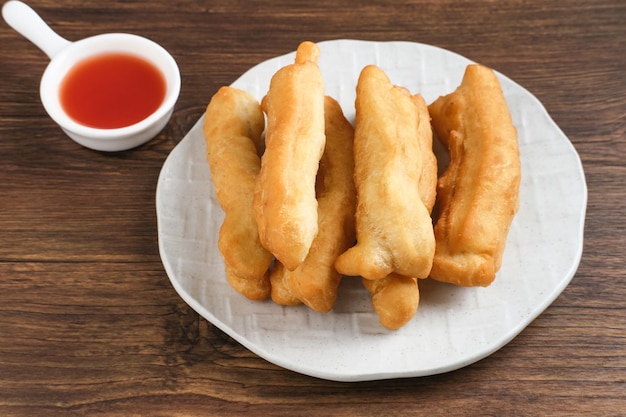 Cakwe or Cakue or Youtiao is traditional Chinese snack long goldenbrown deepfried strip of dough