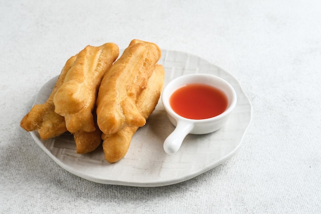 Cakwe or Cakue or Youtiao is traditional Chinese snack long goldenbrown deepfried strip of dough