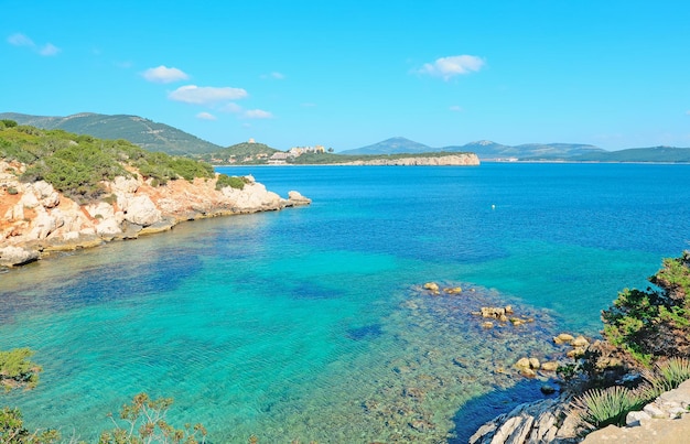 Cala Dragunara rocky shore on a clear day Sardinia