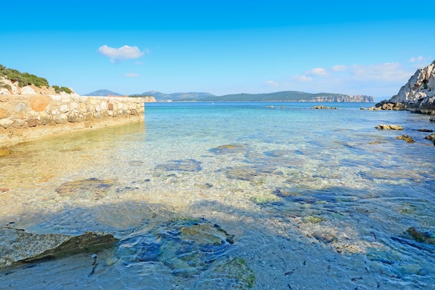Cala Dragunara rocky shore on a clear day Sardinia