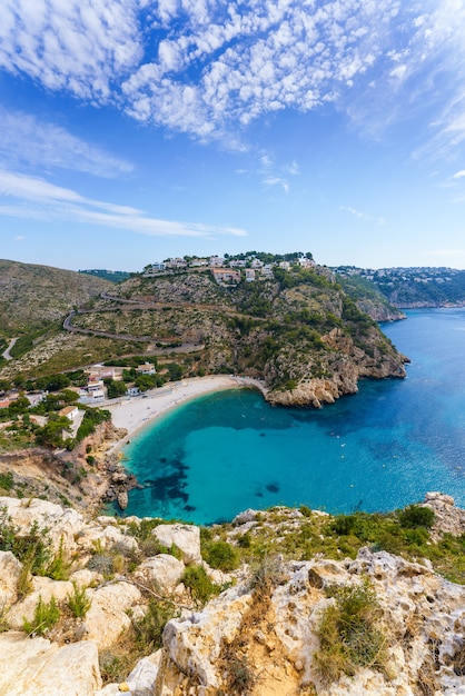 Cala Granadella. Sunny day in a small cove on the Mediterranean coast of Spain. Turquoise water.