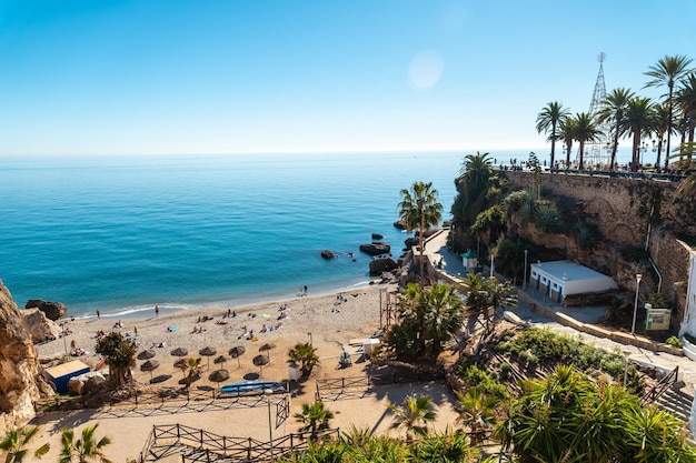 Calahonda beach in the town of Nerja with people sunbathing in spring Andalucia