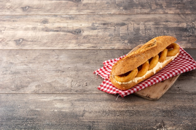 Calamari rings sandwich on wooden table, typical food from Madrid