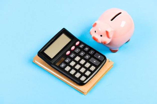 Calculate profit Finance manager wanted Trading exchange Trade market Finance department Credit debt concept Economics and finance Piggy bank pink pig and calculator Business administration