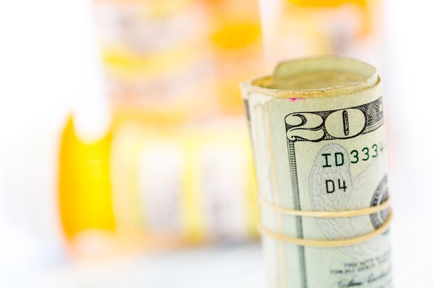 Calculating income tax return with folded cash on a table.