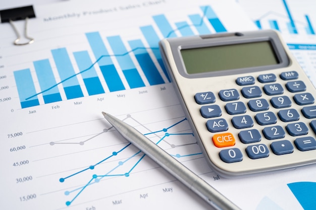 Calculator on chart and graph spreadsheet paper. Finance development, Banking Account, Statistics, Investment Analytic research data economy, Stock exchange trading, Business company concept.