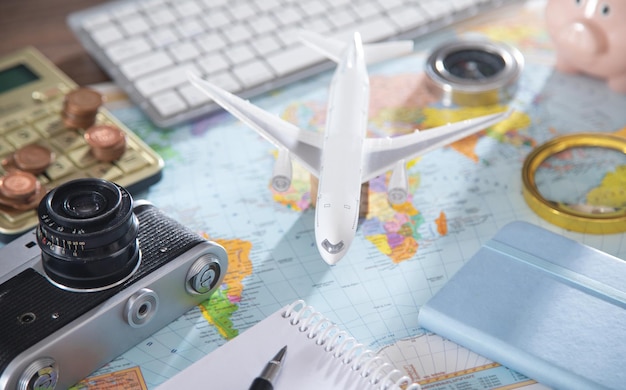 Photo calculator, coins, retro camera, airplane on the world map.