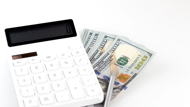 Calculator and dollars isolated on a white background