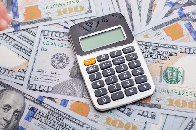 Calculator geplaatst over de bankbiljetten van de Amerikaanse dollar