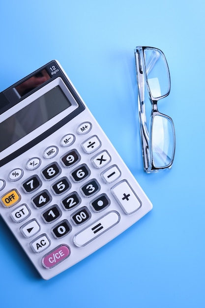 Calculator keypad on a blue background. Top view. Copy space