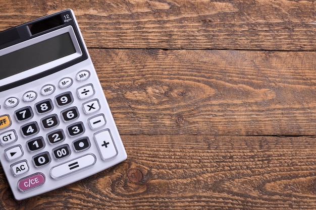 Calculator keypad on a wooden floor background. Top view. Copy space